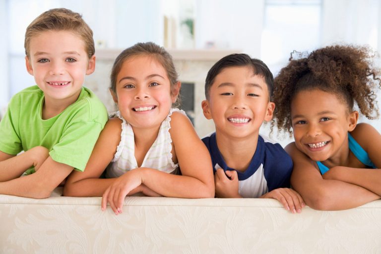 four children smiling at the children's advocacy center